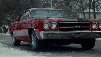 Movie still from “Surviving Christmas” (2004), directed by Mike Mitchell – The front end of a red car; Wide shot, Low angle
