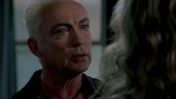 Movie still from “Surviving Christmas” (2004), directed by Mike Mitchell – An older man stares at another man in a mirror; Close Up shot, Over the shoulder angle