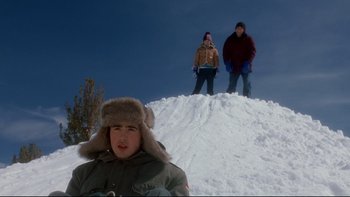 Movie still from “Surviving Christmas” (2004), directed by Mike Mitchell – Two people standing on top of a snow covered hill; Wide shot, Low angle
