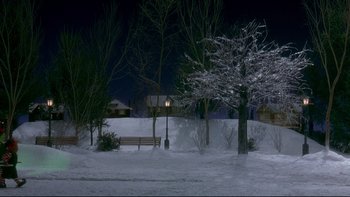 Movie still from “Surviving Christmas” (2004), directed by Mike Mitchell – A park bench in the middle of a snowy night; Extreme Wide shot, High angle