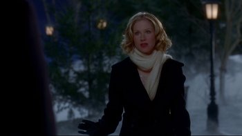 Movie still from “Surviving Christmas” (2004), directed by Mike Mitchell – A woman in a black jacket and a white scarf; Medium shot, Over the shoulder angle