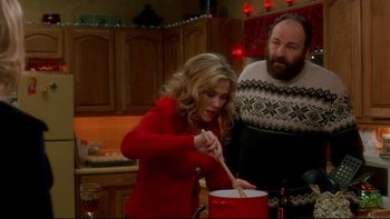 Movie still from “Surviving Christmas” (2004), directed by Mike Mitchell – A man and a woman in a kitchen stirring a pot; Medium shot, High angle