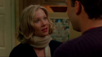Movie still from “Surviving Christmas” (2004), directed by Mike Mitchell – A woman wearing a scarf talking to a man; Close Up shot, Over the shoulder angle