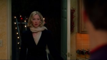 Movie still from “Surviving Christmas” (2004), directed by Mike Mitchell – A woman wearing a black jacket and a white scarf; Medium shot, Over the shoulder angle