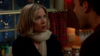 Movie still from “Surviving Christmas” (2004), directed by Mike Mitchell – A woman wearing a white scarf and a black jacket; Close Up shot, Over the shoulder angle