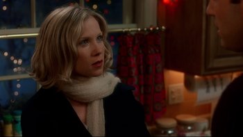 Movie still from “Surviving Christmas” (2004), directed by Mike Mitchell – A woman wearing a white scarf looking to her left; Close Up shot, Over the shoulder angle