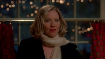 Movie still from “Surviving Christmas” (2004), directed by Mike Mitchell – A person wearing a jacket and a scarf; Close Up shot, Over the shoulder angle