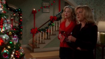 Movie still from “Surviving Christmas” (2004), directed by Mike Mitchell – Two women standing next to each other holding wine glasses; Medium shot, High angle