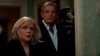 Movie still from “Surviving Christmas” (2004), directed by Mike Mitchell – A man and a woman standing next to each other in a room; Close Up shot, Over the shoulder angle