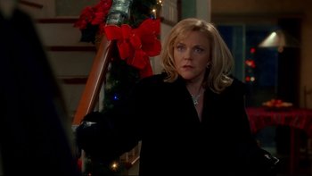 Movie still from “Surviving Christmas” (2004), directed by Mike Mitchell – A woman standing in front of a christmas tree; Medium shot, Over the shoulder angle