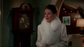Movie still from “Surviving Christmas” (2004), directed by Mike Mitchell – A woman wearing a white coat and a white fur collar; Medium shot, Over the shoulder angle