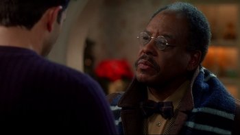 Movie still from “Surviving Christmas” (2004), directed by Mike Mitchell – An older man wearing glasses and a bow tie talking to a younger man; Close Up shot, Over the shoulder angle
