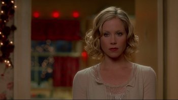 Movie still from “Surviving Christmas” (2004), directed by Mike Mitchell – A woman with blonde hair wearing a white shirt; Close Up shot, Over the shoulder angle