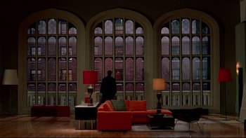 Movie still from “Surviving Christmas” (2004), directed by Mike Mitchell – A man standing in front of a window in a living room; Extreme Wide shot, High angle