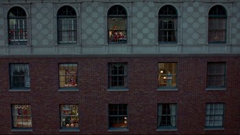 Movie still from “Surviving Christmas” (2004), directed by Mike Mitchell – A group of people in a building looking out of windows; Extreme Wide shot, Overhead angle