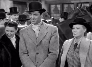 Movie still from “Suspicion” (1941), directed by Alfred Hitchcock – A group of people wearing top hats in a crowd; Medium shot, Low angle