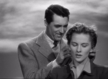 Movie still from “Suspicion” (1941), directed by Alfred Hitchcock – A man and a woman are looking at each other; Close Up shot, Low angle