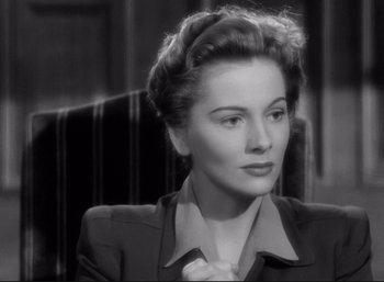 Movie still from “Suspicion” (1941), directed by Alfred Hitchcock – An old black and white photo of a woman in a suit; Close Up shot, High angle