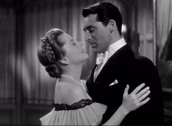 Movie still from “Suspicion” (1941), directed by Alfred Hitchcock – A man and a woman in a black and white photo; Medium shot, Low angle