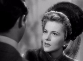 Movie still from “Suspicion” (1941), directed by Alfred Hitchcock – An old black and white photo of a man and a woman; Close Up shot, Over the shoulder angle