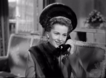 Movie still from “Suspicion” (1941), directed by Alfred Hitchcock – An old photo of a woman talking on a phone; Close Up shot, High angle