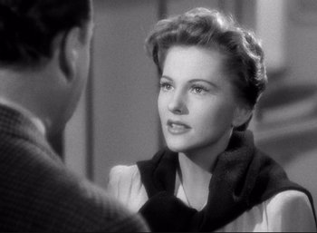 Movie still from “Suspicion” (1941), directed by Alfred Hitchcock – An old photo of a man and a woman talking to each other; Close Up shot, Over the shoulder angle