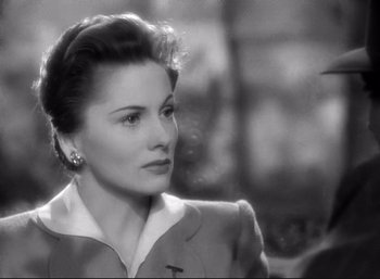 Movie still from “Suspicion” (1941), directed by Alfred Hitchcock – An old black and white photo of a woman looking to her left; Close Up shot, Over the shoulder angle