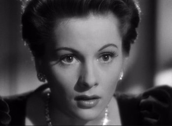 Movie still from “Suspicion” (1941), directed by Alfred Hitchcock – A black - and - white photo of a woman with a necklace; Close Up shot, High angle