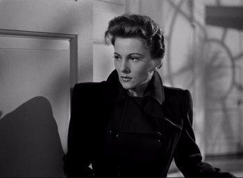 Movie still from “Suspicion” (1941), directed by Alfred Hitchcock – A black and white photo of a woman in a black jacket; Close Up shot, Low angle