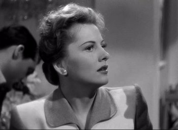 Movie still from “Suspicion” (1941), directed by Alfred Hitchcock – An old black and white photo of a woman looking to her left; Close Up shot, Low angle