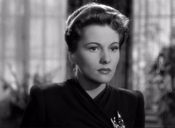 Movie still from “Suspicion” (1941), directed by Alfred Hitchcock – An old photo of a woman in a black jacket; Close Up shot, Low angle