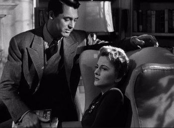 Movie still from “Suspicion” (1941), directed by Alfred Hitchcock – A man and a woman sitting on a chair; Medium shot, Low angle