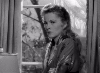 Movie still from “Suspicion” (1941), directed by Alfred Hitchcock – A black - and - white photo of a woman looking out of a window; Close Up shot, Low angle