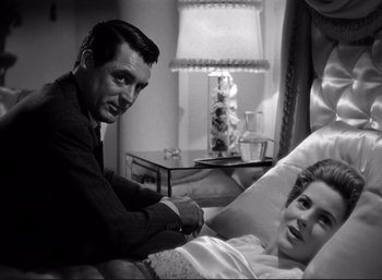 Movie still from “Suspicion” (1941), directed by Alfred Hitchcock – A man and a woman sitting on a bed; Medium shot, Low angle