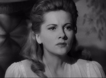 Movie still from “Suspicion” (1941), directed by Alfred Hitchcock – A black - and - white photo of a woman in a white dress; Close Up shot, Low angle