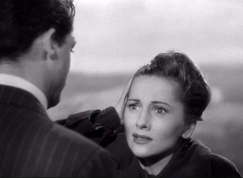 Movie still from “Suspicion” (1941), directed by Alfred Hitchcock – A man and a woman are looking at one another; Close Up shot, High angle