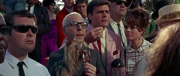 Movie still from “Sweet Charity” (1969), directed by Bob Fosse – A man with a long beard is eating a piece of ice cream; Medium shot, Low angle