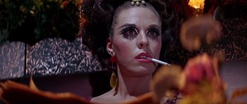 Movie still from “Sweet Charity” (1969), directed by Bob Fosse – A woman is smoking a cigarette while wearing makeup; Close Up shot, Low angle
