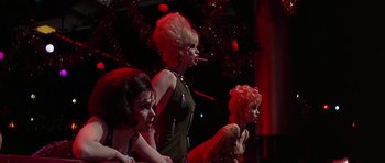 Movie still from “Sweet Charity” (1969), directed by Bob Fosse – A group of women smoking cigarettes in front of a christmas tree; Medium shot, Low angle