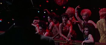 Movie still from “Sweet Charity” (1969), directed by Bob Fosse – A group of women in red and gold dresses; Medium shot, Low angle