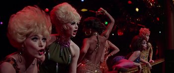 Movie still from “Sweet Charity” (1969), directed by Bob Fosse – A group of women dancing on a dance floor; Medium shot, Over the shoulder angle
