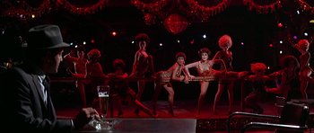 Movie still from “Sweet Charity” (1969), directed by Bob Fosse – A group of burlesque dancers performing on a stage; Wide shot, Low angle