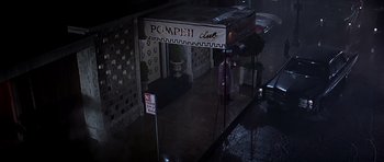 Movie still from “Sweet Charity” (1969), directed by Bob Fosse – The entrance to the pompeii club in the rain; Wide shot, High angle