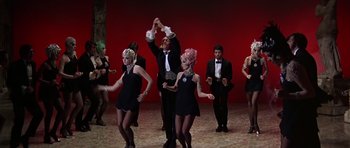Movie still from “Sweet Charity” (1969), directed by Bob Fosse – A group of people dancing in a room; Wide shot, Low angle