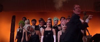 Movie still from “Sweet Charity” (1969), directed by Bob Fosse – A group of people dressed up in costumes and makeup; Medium shot, Low angle