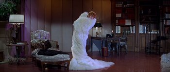 Movie still from “Sweet Charity” (1969), directed by Bob Fosse – A woman standing in a room covered in a long white dress; Wide shot, High angle