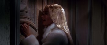 Movie still from “Sweet Charity” (1969), directed by Bob Fosse – A woman with long blonde hair wearing a white fur coat; Close Up shot, Over the shoulder angle