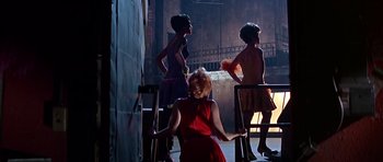 Movie still from “Sweet Charity” (1969), directed by Bob Fosse – A group of women standing next to each other in a room; Wide shot, Low angle