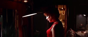 Movie still from “Sweet Charity” (1969), directed by Bob Fosse – A woman in a red dress standing in a dimly - lit room; Close Up shot, Low angle