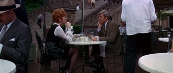 Movie still from “Sweet Charity” (1969), directed by Bob Fosse – A man and a woman sitting at an outdoor table; Medium shot, Over the shoulder angle